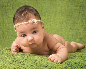 two-month-old girl with decoration on a head 