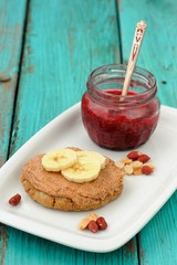 Homemade cookie with peanut butter and banana and raspberry jam