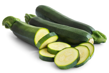 Courgettes whole and sliced isolated on white.
