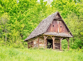 Fototapeta na wymiar Old abandoned wooden traditional house with arched porch .