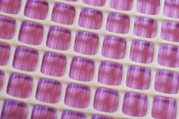 White net with squares on magenta background

