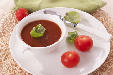 tomato soup in a white bowl 
