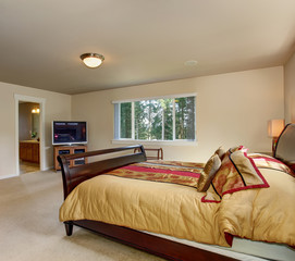 Elegant master bedroom with wooden bed frame.