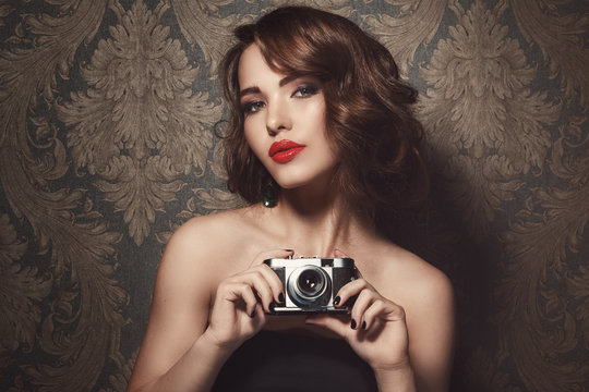 Woman With A Vintage Camera