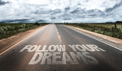 Follow Your Dreams written on rural road