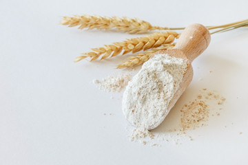 wholemeal flour in wooden spoon