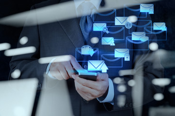 businessman hand use smart phone computer with email icon as con