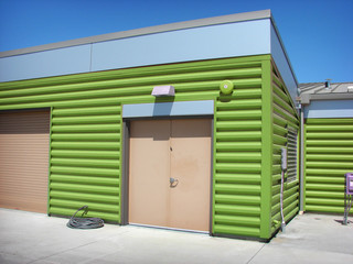 modern green metal building with doors