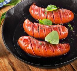Fried sausages on a pan