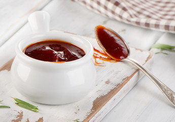 Sweet bbq sauce in  white bowl.