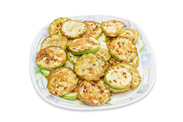 Zucchini, fried in batter on dish on a light background