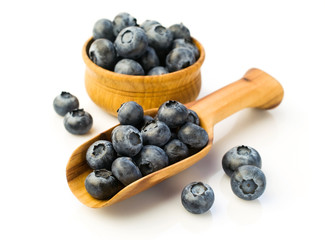 Ripe blueberries in a wooden scoop