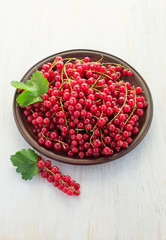 Red currant in a clay plate