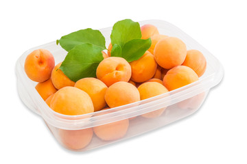 Ripe apricot in plastic tray closeup