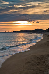 Waves on a sandy beach at sunset, west coast of Sithonia