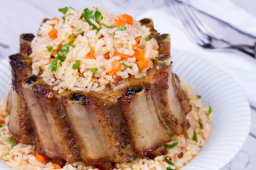 Pork Ribs With Rice, Carrot, Paprika Pepper And Parsley