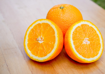 Slice of orange on wooden table.