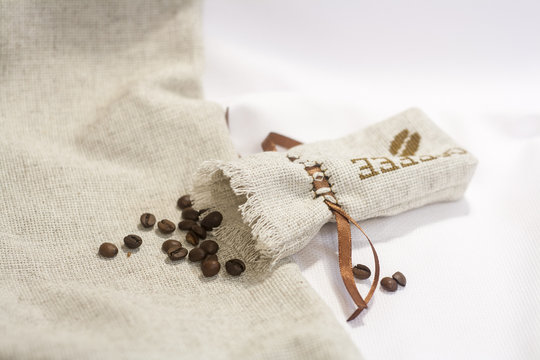 Sachet with embroidery stitch with coffee beans, selective focus