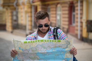 Young hipster man with map