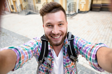 Handsome man making selfies