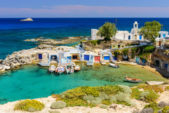 Scenic Mandrakia village (traditional Greek village by the sea) with sirmate - traditional fishermen's houses, Milos island, Cyclades, Greece.