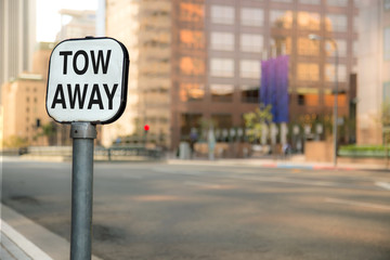 Tow away sign bokeh blurred blurry background urban city business district buildings downtown