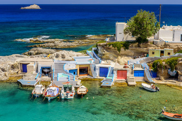 Scenic Mandrakia village (traditional Greek village by the sea, the Cycladic-style) with sirmate - traditional fishermen's houses, Milos island, Greece.