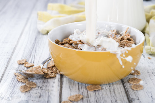 Pouring Milk In A Bowl With Cornflakes