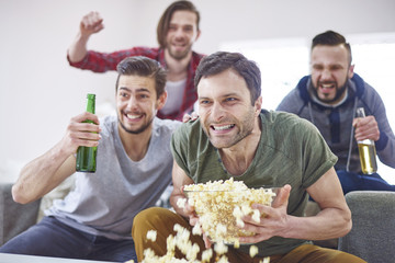 Fototapeta premium Excited men watching match on TV