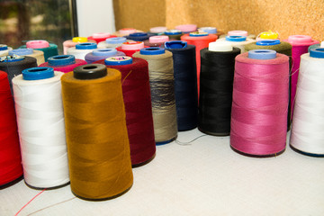 Many reels of  threads standing on the table