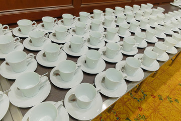 Many white coffee cups are provided below.