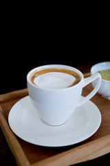 hot cappuccino on black background