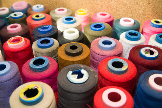 Many reels of  threads standing on the table