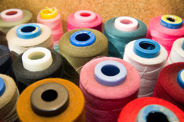 Many reels of  threads standing on the table