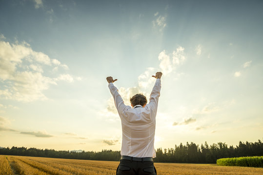 Businessman Raising Arms for Success at the Field