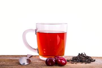 fresh berry and cup of tea on old wooden background, selective f