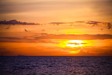 amazing sunset over beautiful sky with clouds, rippling waters