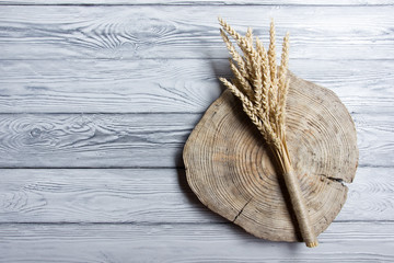 Wheat Ears on Wooden Table. Sheaf of Wheat over Wood Background. Harvest concept. Top view