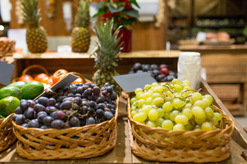 grape in baskets with nameplates at food market