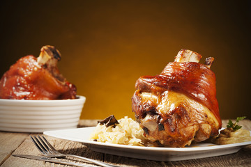 Roast pork knuckle served with boiled cabbage, bread, horseradis