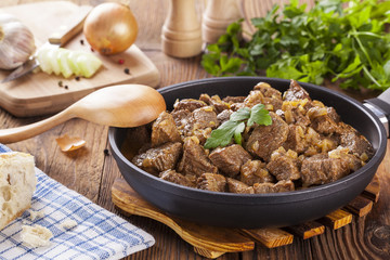 Beef stew - wooden background