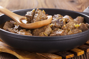 Beef stew - wooden background