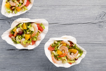 Shrimp salad with grapefruit, orange and roasted peanuts. - Serv
