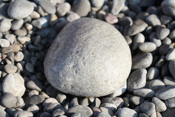 Fototapeta na wymiar Stone background. Stones on the beach. Rounded rocks on the river.