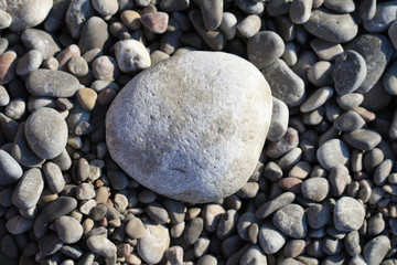 Fototapeta na wymiar Stone background. Stones on the beach. Rounded rocks on the river.
