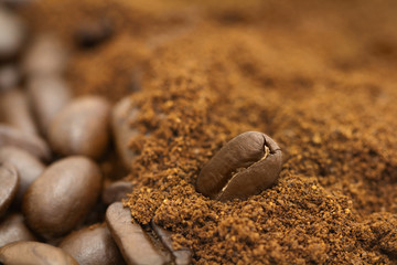 Fototapeta na wymiar Coffee beans background. Roasted coffee. Brown background. Ground coffee and whole bean coffee. 
