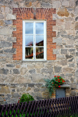 Fototapeta na wymiar window on rustic stone wall