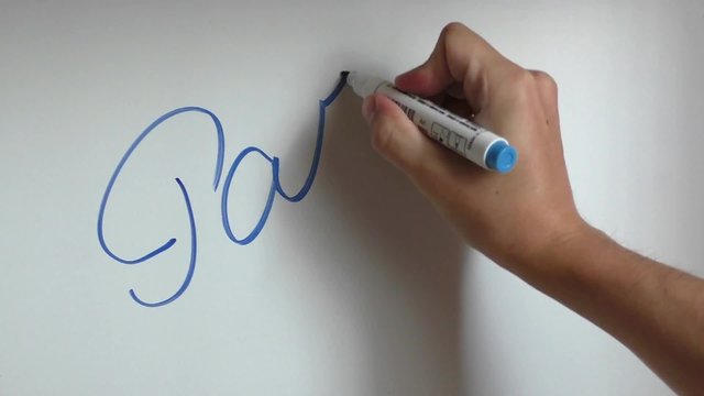 Hand writing and erasing words part eight on white board with blue marker