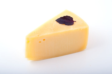 Tasty cheese with a basil leaf, isolated
