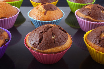 Freshly baked muffins on a roasting pan